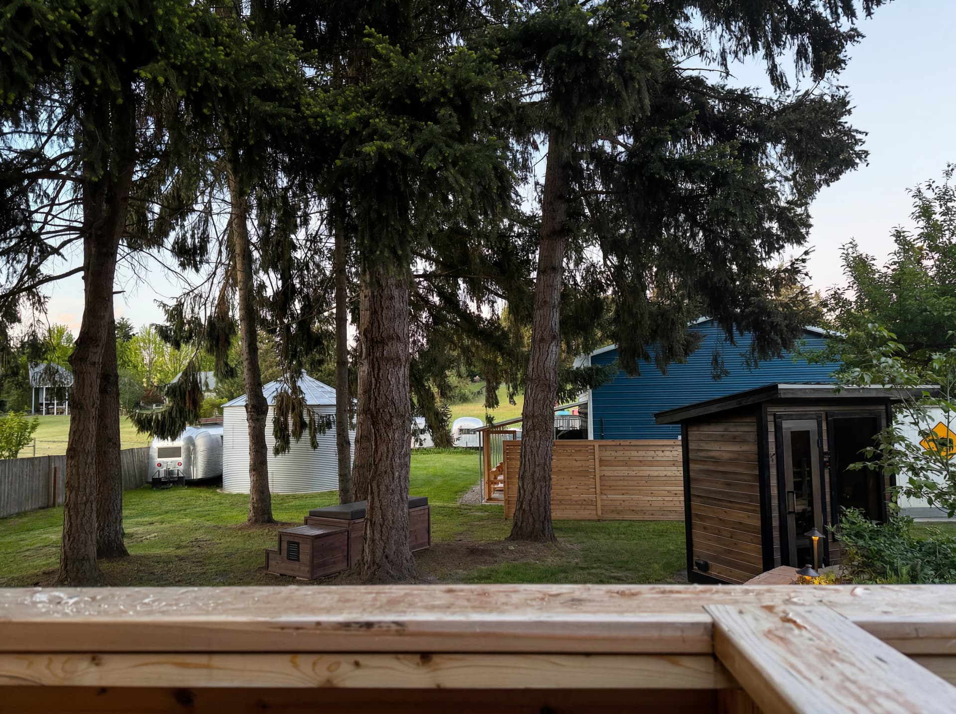 Hand-built cedar sauna at golden hour in the founder's backyard, Graham, WA — the working tour space