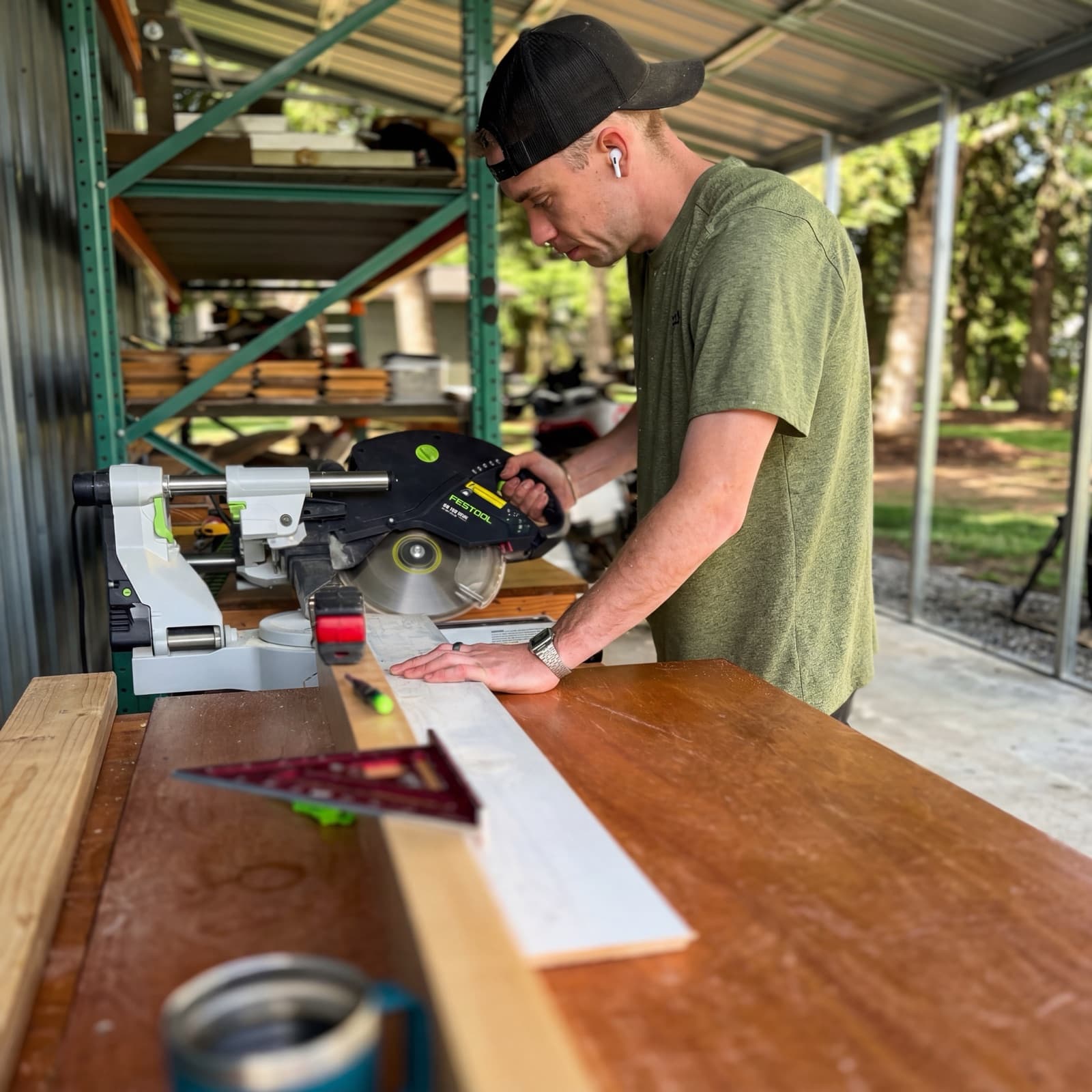 The founder at the miter saw in the Yutori shop, Graham, WA — cutting cedar stock for a build